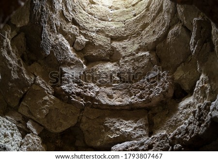 An old stone well from inside. Picture taken from below. 