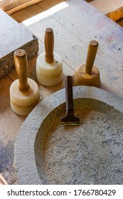 Old Stonemasonry Work Tools At A Stone Bowl On A Workbench