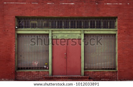 An old storefront on the side of a red brick building