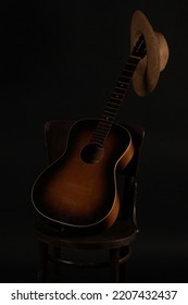 Old Straw Hat, Guitar And Chair