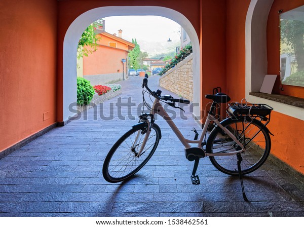 Old street with bicycle parked. Vintage style and\
bike public vehicle tourism. Summer background. Lifestyle design. \
Travel background. Traditional european sport. Spring vacation.\
Mixed media.