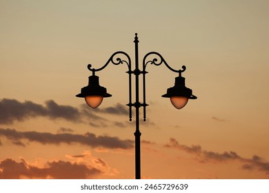 Old street lamp post in town against twilight dusk, sky - Powered by Shutterstock