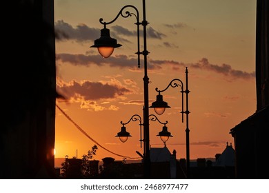 Old street lamp posts in town against twilight dusk, sky - Powered by Shutterstock