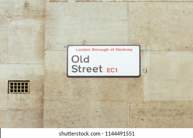 Old Street name sign. Old Street is a street in central and east London that runs west to east from Goswell Road in Clerkenwell to the crossroads of Shoreditch High Street and Hackney Road