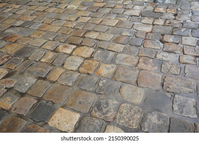 Old Street Pavers Textured Background. Path Paving Wet Surface In Rainy Day.