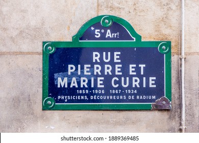old street sign  Rue Pierre et Marie Curie - english: street Pierre and Marie Curie in the old historic part of Paris, France with text physicist, explorer of the element radium