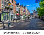 Old street with tables of cafe in Mechelen, Belgium. Mechelen is a city and municipality in the province of Antwerp, Flanders, Belgium.