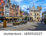 Old street with tables of cafe in Mechelen, Belgium. Mechelen is a city and municipality in the province of Antwerp, Flanders, Belgium.