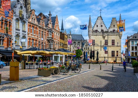 Old street with tables of cafe in Mechelen, Belgium. Mechelen is a city and municipality in the province of Antwerp, Flanders, Belgium.