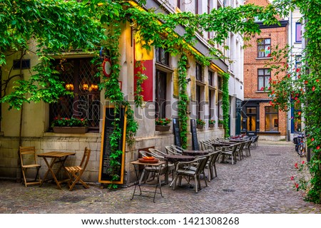Old street with tables of restaurant in Antwerpen (Antwerp), Belgium. Cozy cityscape in Antwerp