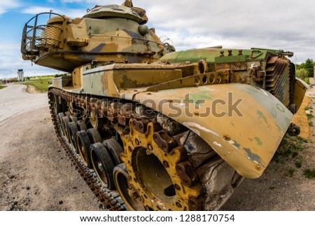 Old street tank featuring army colors,rusted steel, featuring details on mudguards,drive sprockets,turret ring,tracks and side skirts