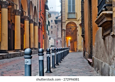 Old Street View Bologna City, Italy. Cobble Stone Street With Bollards. Renaissance Buildings.