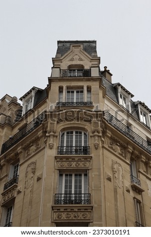 Old streets of Paris. French flag on the facade of the building