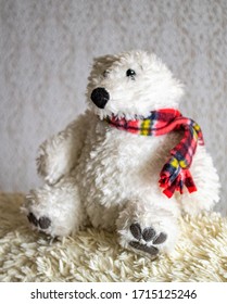 An Old Stuffed Polar Bear On The Sofa.