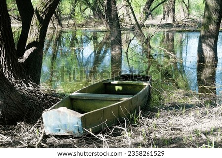 Old style boat, primitive box-shaped wooden boat for sailing in small inland reservoirs on banks of dead arm of river and floodplain forest. Old Slavs were buried in such boats. Don River. Russia