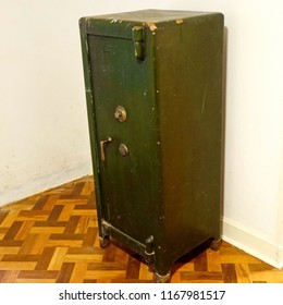 Old Style Large Size Safe Deposit Box Isolated On Wooden Floor