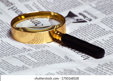 old style magnifying glass lens and newspaper. concept for fact checking, politics - Shutterstock ID 1750168328