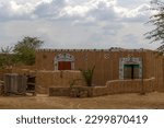 an old style mud house in rural areas of desert cholistan , Punjab, mud house with decorated doors in Hindu village of south Punjab 