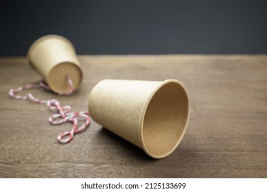 Old Style Paper Cup Phone With Thread, Classic Or Toy Phone On The Wood Table, Telecommunications