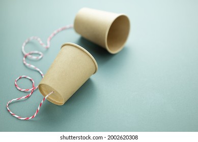 Old style phone, two paper cups with string