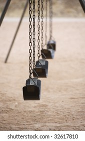 Old style playground swings with chains and rubber seats