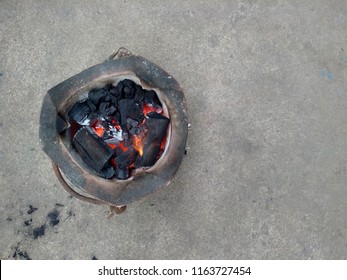 Old Style Rocket Stove With Charcoal And Fire, Top View