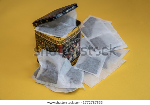 Old style tea caddy with\
tea bags.