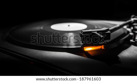 old style turntable with needle - b&w and orange light 