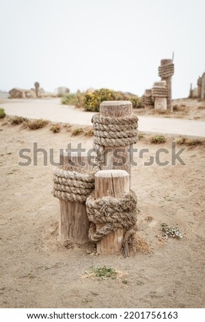 old style Wooden Mooring post with rope in Morro bay California. Aesthetic travel background