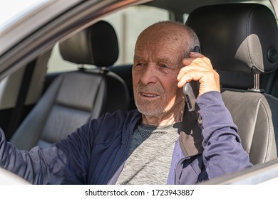 Old Successful Businessman Talking On The Phone Sitting In His Elite Car, Talks And Business Meetings Concept