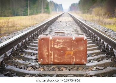 Old suitcase on the railway
