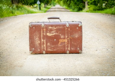 Old suitcase on the rural road
