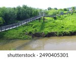 Old suspension bridge over the Suenga river in Maslyaninsky District of Novosibirsk Oblast. 