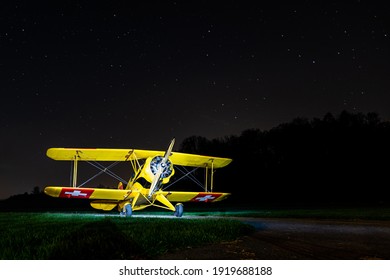 old Swiss air force biplane warbird photographed under a beautiful nightsky with stars
