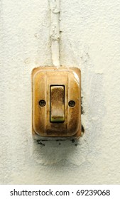 Old switch on white wall