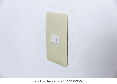 Old switch panel on white wall.