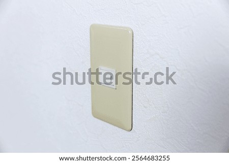 Old switch panel on white wall.