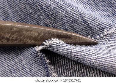 old tailor scissors on blue jean 

