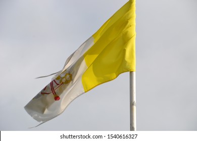 Old Tattered Papal Flag Blowing On A Story Day