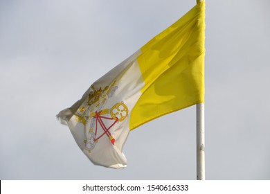 Old Tattered Papal Flag Blowing On A Story Day