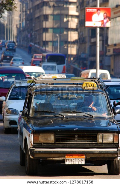 An old\
taxi car moves along a street in the capital. The Arab Spring\
begins. Cairo, Egypt, Middle East, March 27,\
2011.