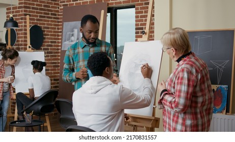 Old Teacher And Student Helping African American Man To Draw Vase On Canvas. Diverse Team Of People Explaining Artisitc Technique To Develop Drawing Skills In Art Class, New Years Resolutions.