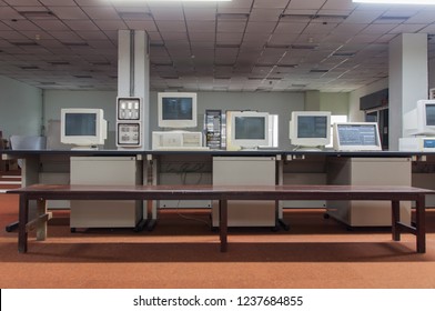 Old Technology System Telephone In Control Room. Computer On Table With 
Long Wooden Chair And Red Carpet In Vintage Monitor Room Technical Support.