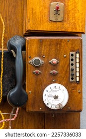 Old telephone device on a wooden panel - Shutterstock ID 2257336033