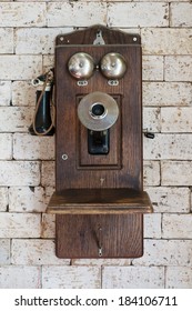 Old Telephone Hanging On Brick Wall