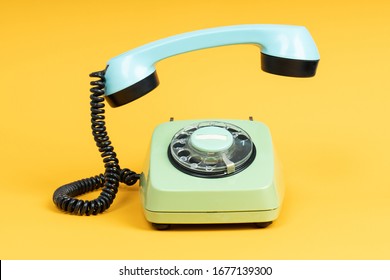 Old Telephone On Yellow Background. Vintage Phone With Taken Off Receiver