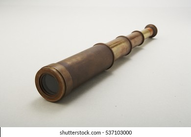 Old telescope close-up isolated on white background
