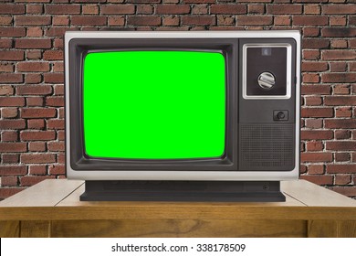 Old Television With Chroma Key Green Screen And Brick Wall.