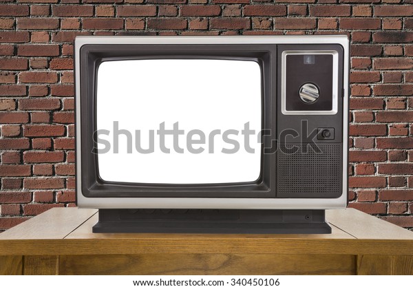 Old\
television with cut out screen and brick\
wall.