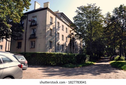 An Old Tenement House In The Szydłówek Housing Estate And The Road And Parked Cars